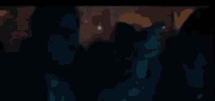 a group of people are standing in a dark room .