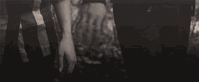 a black and white photo of a person holding hands