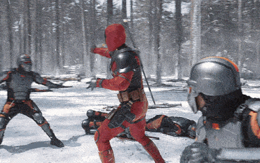 a man in a red costume is standing in the snow