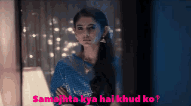 a woman in a blue saree with the words samajhta kya hai khud ko written below her