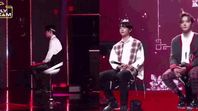 a man wearing a crown is sitting on a stage with two other men