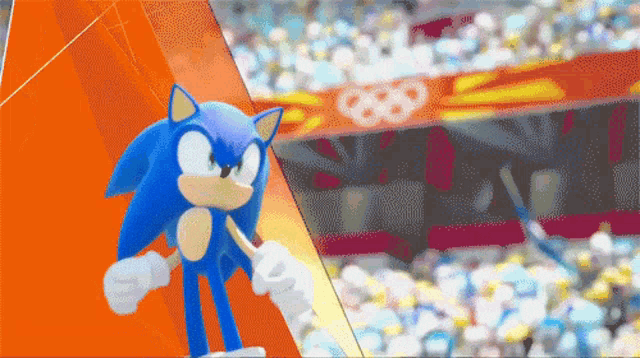 sonic the hedgehog is standing in front of a stadium with the olympic rings in the background