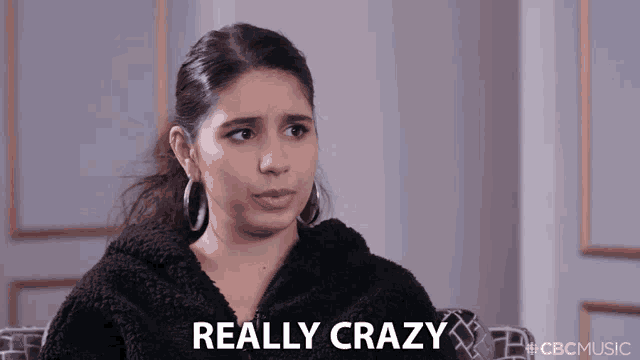 a woman is sitting on a couch with the words really crazy behind her