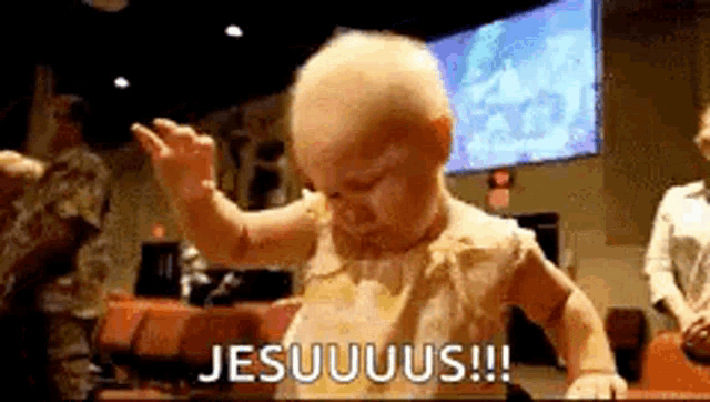 a baby is dancing in a church with the words jesuuus written on the bottom of the image .