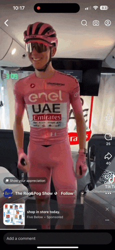 a man wearing a pink enel uae jersey
