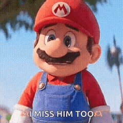 a close up of a mario doll with the words `` i miss him too '' .