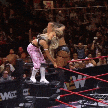 two women in a wrestling ring with a sign that says wtx