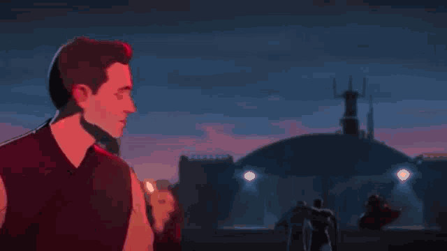 a woman in a black suit is kneeling down next to a man in a red light .