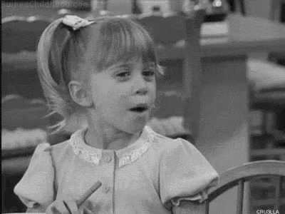 a little girl is sitting in a chair with a pencil in her hand .
