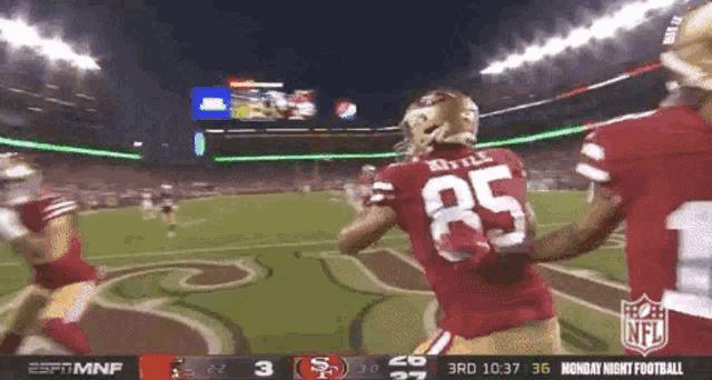 a football player with the number 85 on his back is running on the field