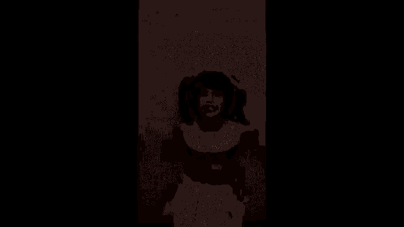 a woman in a cheerleader costume is standing in front of a wall .