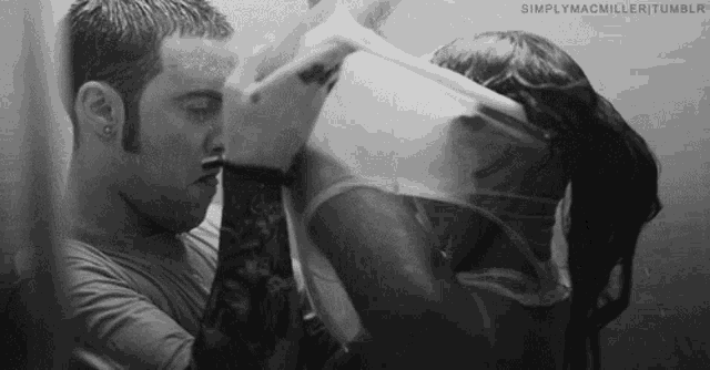 a black and white photo of a man and woman in a shower