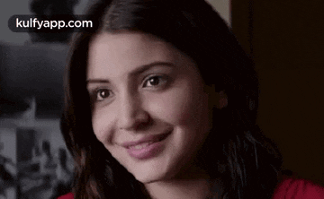 a close up of a woman 's face with a smile .