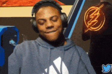 a man wearing headphones and a blue hoodie with the word adidas on it