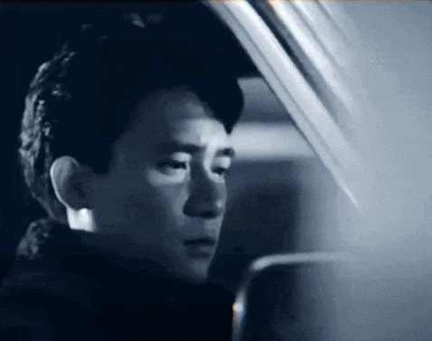 a black and white photo of a man in a car