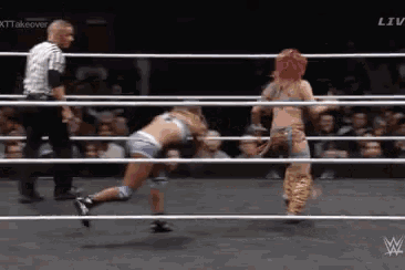 two women are wrestling in a ring with a referee and the word liv on the bottom right