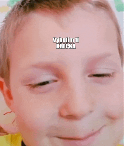 a close up of a child 's face with the words vyhulim ti krecka written above it