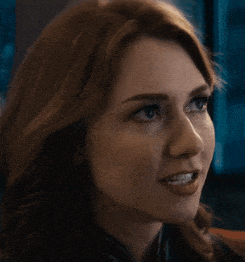 a close up of a woman 's face with the words " anything " below it