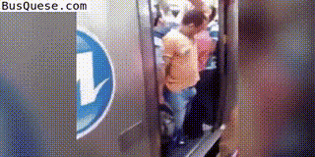 a group of people are standing in an elevator with an arrow pointing down