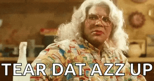 a woman in a wig and glasses says tear dat azz up