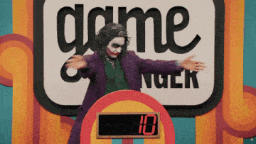 a man in a joker costume stands in front of a sign that says game nuck
