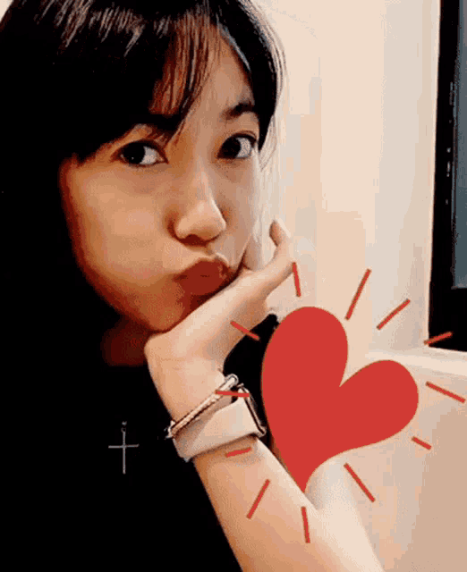 a woman wearing an apple watch is making a funny face
