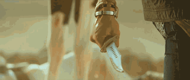 a person holding a knife in their hand with a few lines on it