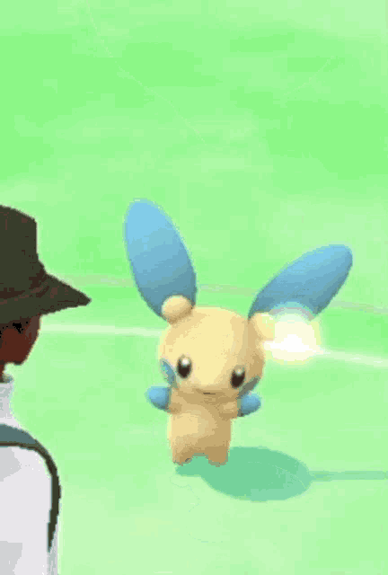 a man in a hat is standing next to a cartoon rabbit with blue wings in a video game .