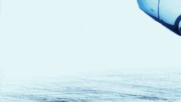 a robot is flying over a body of water in the air .