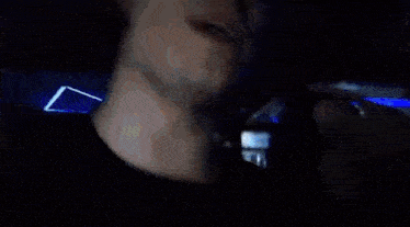 a blurry picture of a man 's face with a blue light coming out of it .