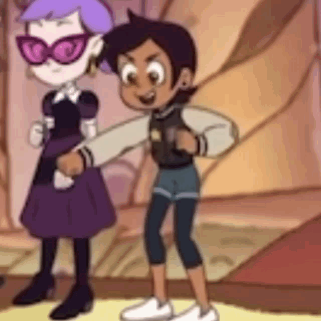 a boy and a girl are standing next to each other in a room .