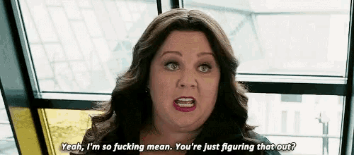 a woman is talking to another woman in front of a window and saying yeah , i 'm so fucking mean .