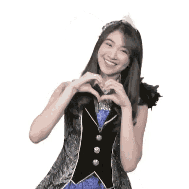 the girl is wearing a tiara and making a peace sign with her hands