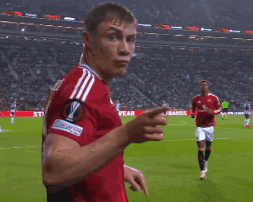 a soccer player wearing a red jersey with the number 9 on it