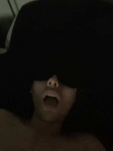 a person with their mouth open and their eyes closed