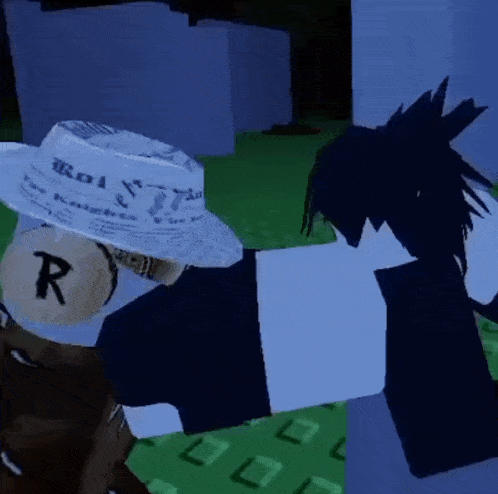 a person wearing a white hat with the letter r on it is laying on the ground .