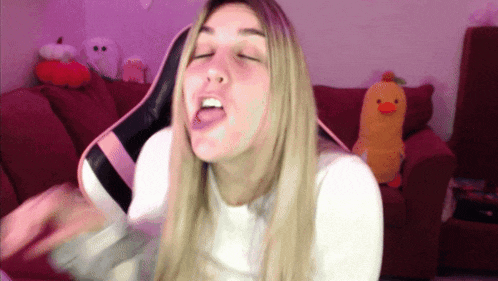 a woman with her eyes closed and her tongue out