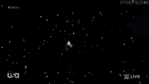 a man is holding a lantern in a dark room .