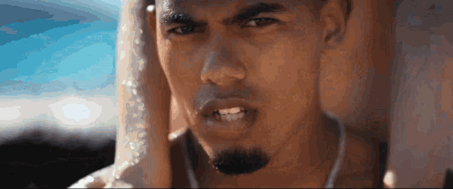 a close up of a man 's face with a woman behind him