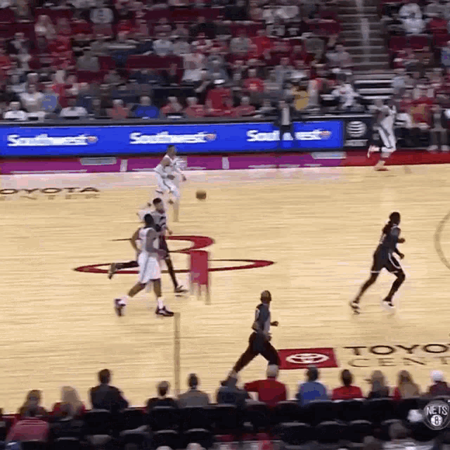 a basketball game is being played on a court with toyota and southwest ads