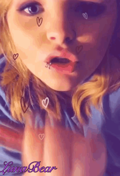 a girl with hearts on her face and the name luna bear on the bottom right