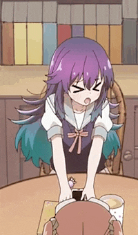 a girl with purple hair is sitting at a table with a book .
