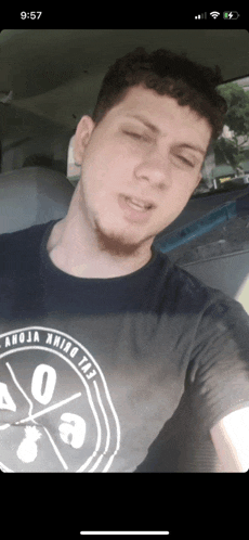 a man taking a selfie with a shirt that says anoja among us