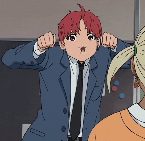 a boy with red hair is wearing a suit and tie and making a funny face