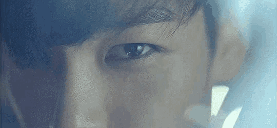 a close up of a man 's eye with a reflection of a window .