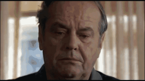 a close up of a man 's face with a serious expression