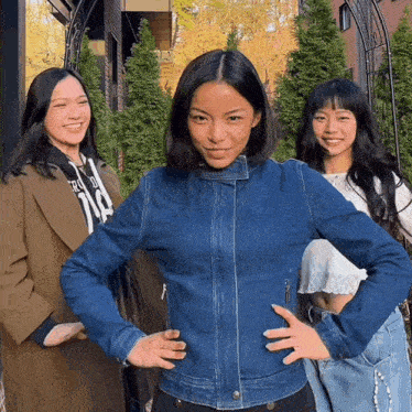 a woman wearing a denim jacket has the number 118 on her shirt