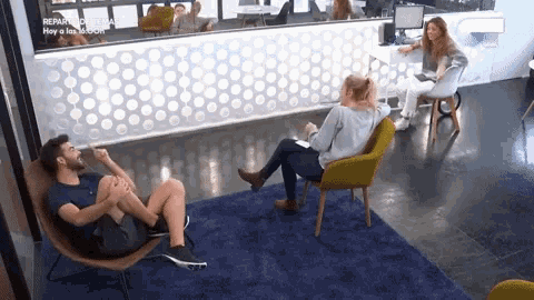 a group of people sitting in chairs in front of a counter that says repara