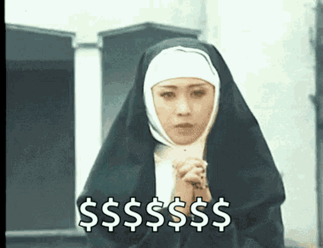 a nun is holding a rosary in her hands and praying while wearing a black robe .