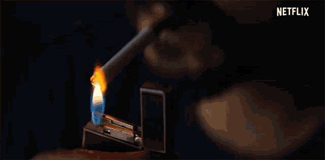 a close up of a person lighting a cigarette with a lighter